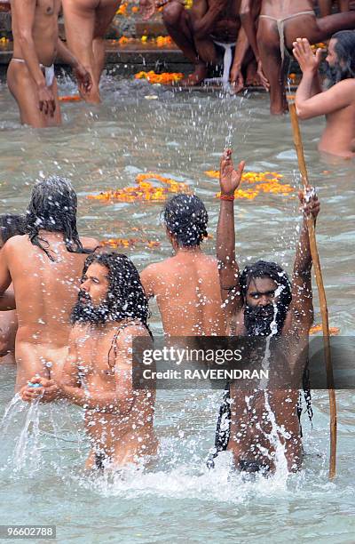 Indian Naga Sadhus - Holy Men - bathe at Har-ki-Pauri at the Ganga River during the First Shahi Snan - Royal Bath - on Maha Shivratri during the...