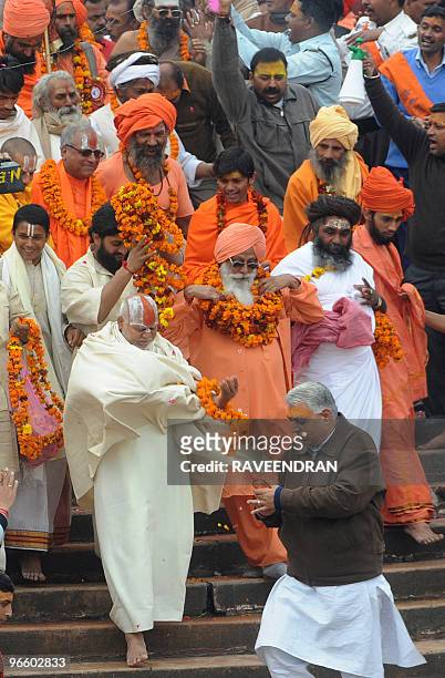 Indian Sadhus - Holy Men - walk to bathe at Har-ki-Pauri at the Ganga River during the First Shahi Snan - Royal Bath - on Maha Shivratri during the...
