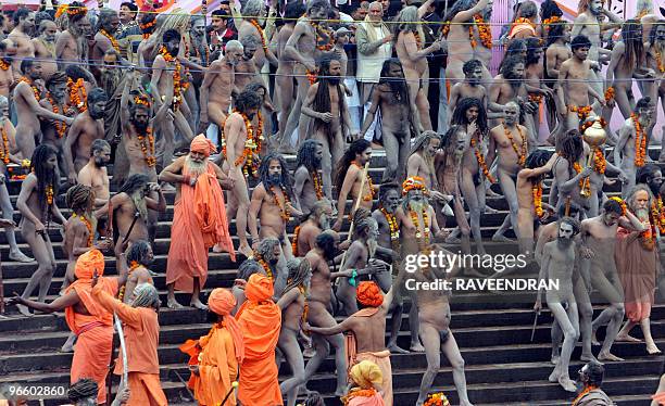 Indian Naga Sadhus - Holy Men - walk to bathe at Har-ki-Pauri at the Ganga River during the First Shahi Snan - Royal Bath - on Maha Shivratri during...