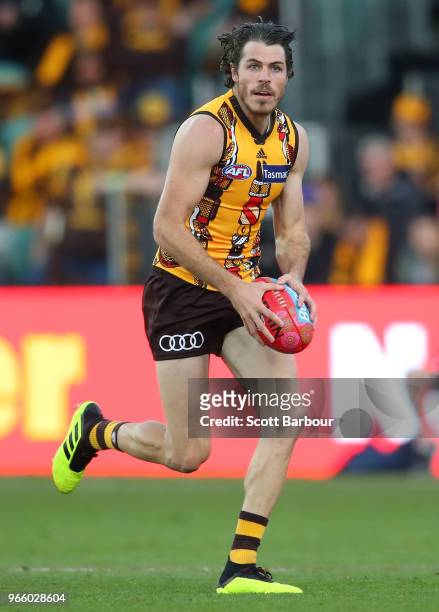 Isaac Smith of the Hawks runs with the ball during the round 11 AFL match between the Hawthorn Hawks and the Port Adelaide Power at University of...