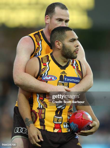 Jarman Impey of the Hawks is congratulated by Jarryd Roughead of the Hawks after marking the ball in the final minutes during the round 11 AFL match...