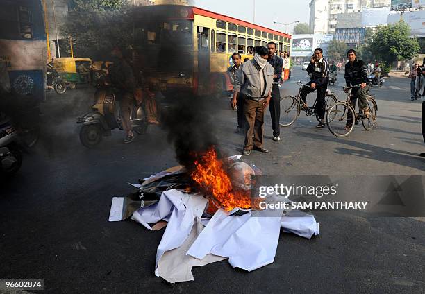 Supporters from the Vishva Hindu Parishad and Bajrang Dal burn a poster of the Bollywood film 'My Name is Kahn' starring Bollywood actor Shah Rukh...