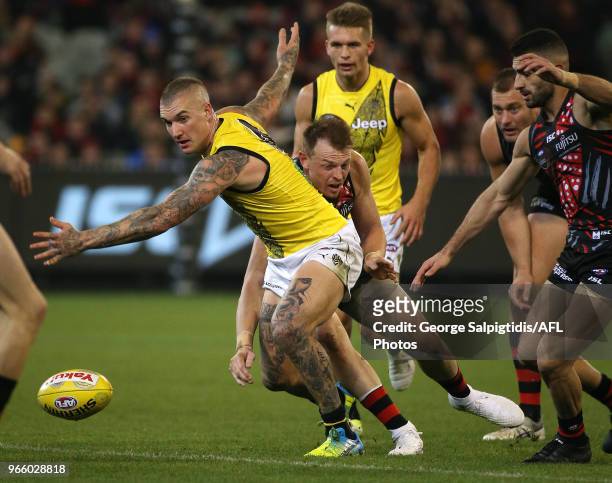 Dustin Martin of the Tigers breaks away from Brendon Goddard of the Bombers during the round 11 AFL match between the Essendon Bombers and the...