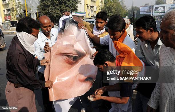 Supporters from the Vishva Hindu Parishad and Bajrang Dal prepare to burn a poster of the Bollywood film 'My Name is Kahn' starring Bollywood actor...