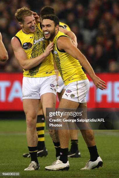 Shane Edwards of the Tigers celebrates his goal with Josh Caddy during the round 11 AFL match between the Essendon Bombers and the Richmond Tigers at...