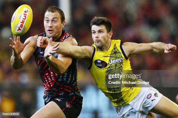 Trent Cotchin of the Tigers spoils Tom Bellchambers of the Bombers during the round 11 AFL match between the Essendon Bombers and the Richmond Tigers...