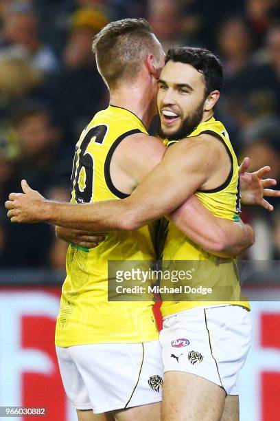Shane Edwards of the Tigers celebrates a goal with teammates during the round 11 AFL match between the Essendon Bombers and the Richmond Tigers at...
