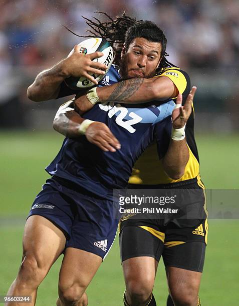 Rene Ranger of the Blues is tackled by Ma'a Nonu of the Hurricanes during the round one Super 14 match between the Blues and the Hurricanes at North...