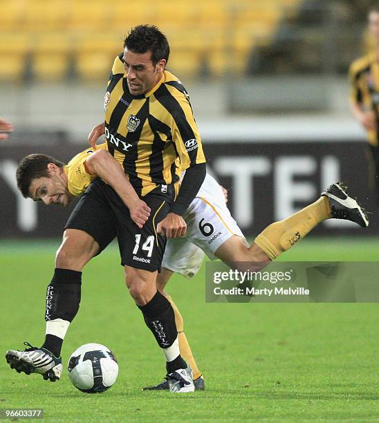 Adrian Caceres of the Phoenix is tackled by Brady Smith of the Mariners during the round 27 A-League match between the Wellington Phoenix and the...