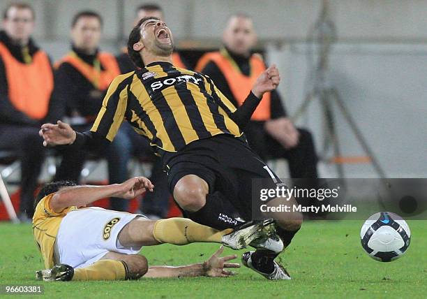 Daniel of the Phoenix is tackled by Andrew Clark of the Mariners during the round 27 A-League match between the Wellington Phoenix and the Central...