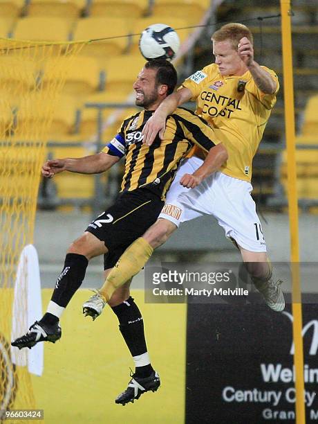 Andrew Durante captain of the Phoenix jumps for the ball with Mathew Simon of the Mariners during the round 27 A-League match between the Wellington...