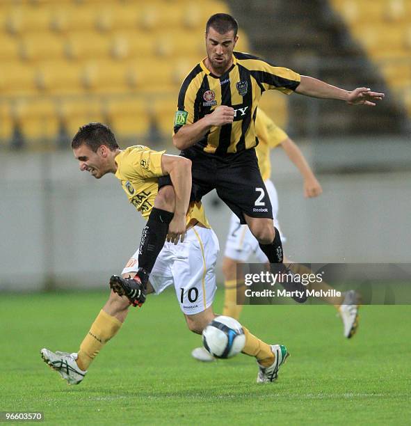 Panagiotis Nikas of the Mariners is landed on by Manny Muscat of the Phoenix during the round 27 A-League match between the Wellington Phoenix and...