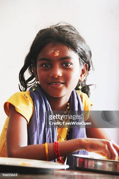 Portrait of a young and pretty indian hindu pilgrim girl with devotional signs on her forehead in a restaurant in Kumily on January 02, 2010 in...
