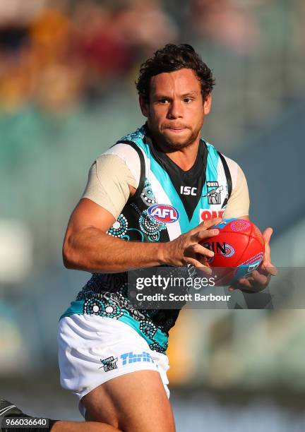 Steven Motlop of the Power runs with the ball during the round 11 AFL match between the Hawthorn Hawks and the Port Adelaide Power at University of...