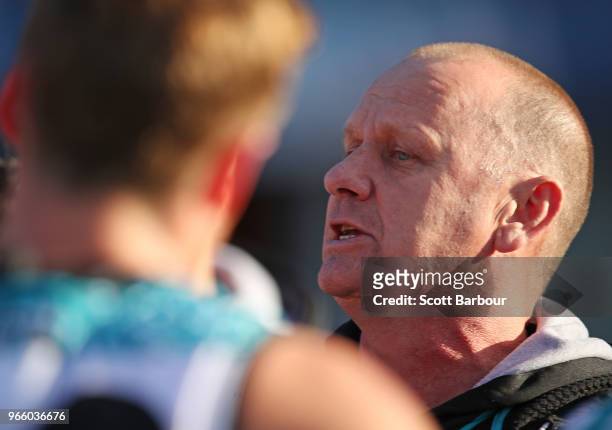 Ken Hinkley, coach of the Power speaks to his team during a quarter time break during the round 11 AFL match between the Hawthorn Hawks and the Port...