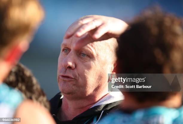 Ken Hinkley, coach of the Power speaks to his team during a quarter time break during the round 11 AFL match between the Hawthorn Hawks and the Port...