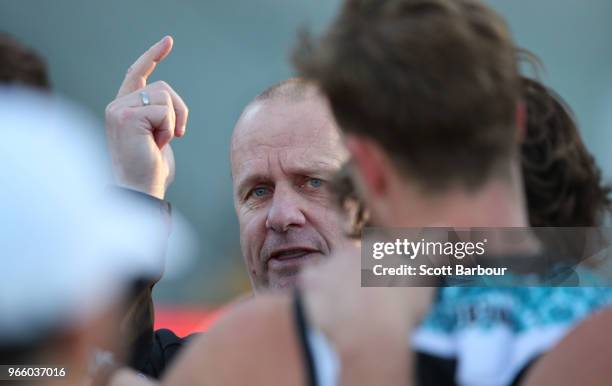 Ken Hinkley, coach of the Power speaks to his team during a quarter time break during the round 11 AFL match between the Hawthorn Hawks and the Port...