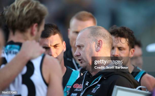 Ken Hinkley, coach of the Power speaks to his team during a quarter time break during the round 11 AFL match between the Hawthorn Hawks and the Port...