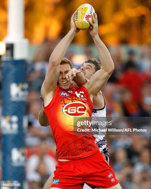 Rory Thompson of the Suns and Tom Hawkins of the Cats compete for the ball during the 2018 AFL round 11 match between the Gold Coast Suns and the...