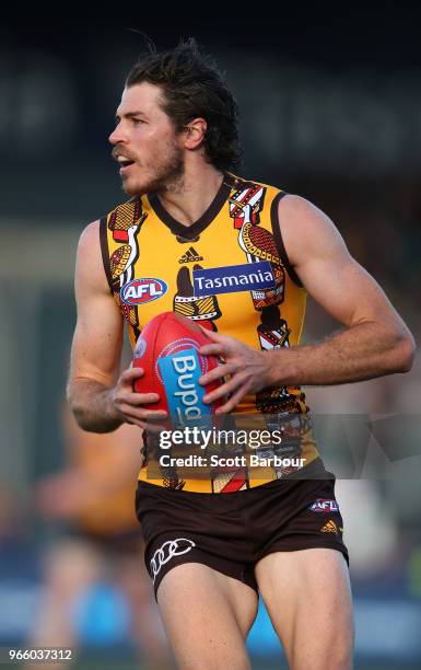 Isaac Smith of the Hawks runs with the ball during the round 11 AFL match between the Hawthorn Hawks and the Port Adelaide Power at University of...