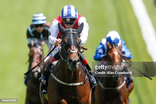 Adam Kirby riding Connect win The Investec Private Banking Handicap Stakes during Investec Derby Day at Epsom Downs Racecourse on June 2, 2018 in...