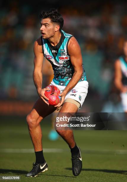 Riley Bonner of the Power runs with the ball during the round 11 AFL match between the Hawthorn Hawks and the Port Adelaide Power at University of...