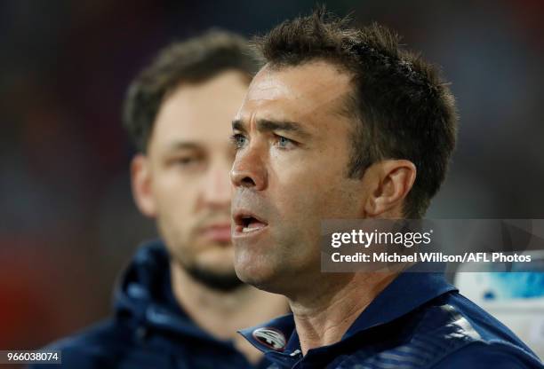 Chris Scott, Senior Coach of the Cats addresses his players during the 2018 AFL round 11 match between the Gold Coast Suns and the Geelong Cats at...