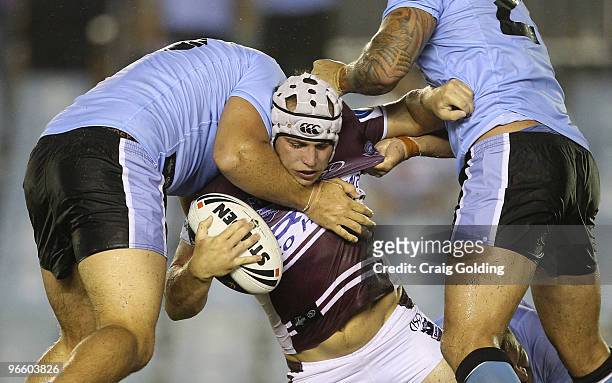 Jamie Buhrer of the Sea Eagles is tackled during the NRL trial match between the Cronulla Sutherland Sharks and the Manly Warringah Sea Eagles at...