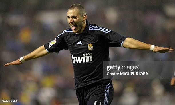Real Madrid's French forward Karim Benzema celebrates after scoring against Deportivo during a Spanish league football match at the Riazor Stadium in...