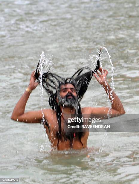 An Indian Naga Sadhu - Holy Man - bathes at Har-ki-Pauri in the River Ganges in Haridwar on February 12 during the First Shahi Snan - Royal Bath - on...