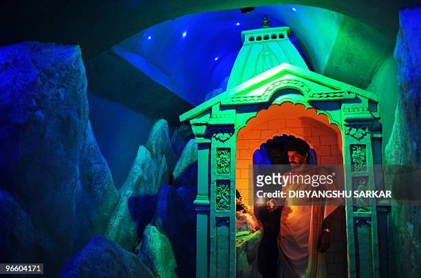 An Indian Hindu priest performs puja - prayer - inside a Lord Shiva temple in Bangalore on February 10, 2010. A portion of the temple complex has...