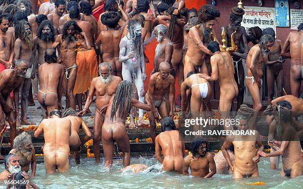 Indian Naga Sadhus - Holy Men - bathe at Har-ki-Pauri at the Ganga River during the First Shahi Snan - Royal Bath - on Maha Shivratri during the...