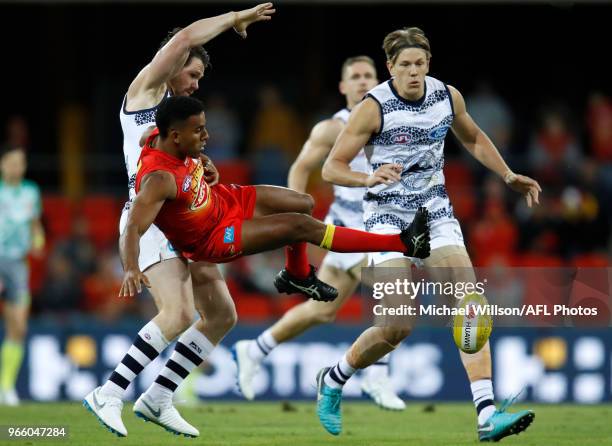 Touk Miller of the Suns and Patrick Dangerfield of the Cats compete for the ball during the 2018 AFL round 11 match between the Gold Coast Suns and...