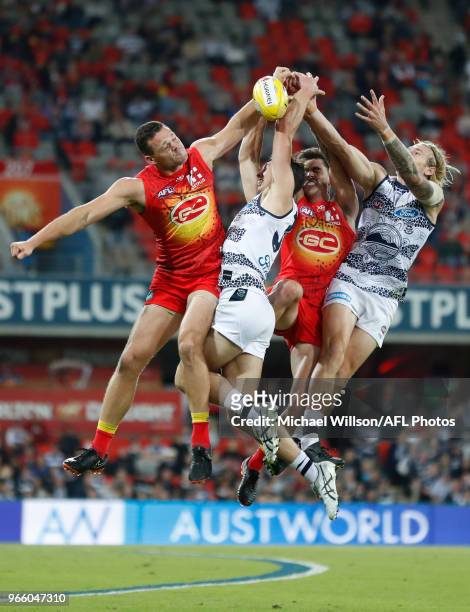 Steven May of the Suns, Jack Henry of the Cats, Alex Sexton of the Suns and Tom Stewart of the Cats compete for the ball during the 2018 AFL round 11...