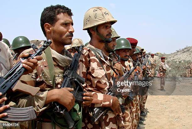 Yemeni troops gather to meet Defence Minister Mohammad Nasser Ahmad during his visit to the frontline in the northern province of Saada on February...