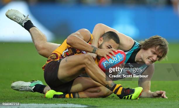 Jarman Impey of the Hawks and Jared Polec of the Power compete for the ball during the round 11 AFL match between the Hawthorn Hawks and the Port...