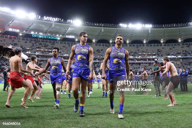 Brendon Ah Chee and Lewis Jetta of the Eagles lead the team from the field after winning the round 11 AFL match between the West Coast Eagles and the...