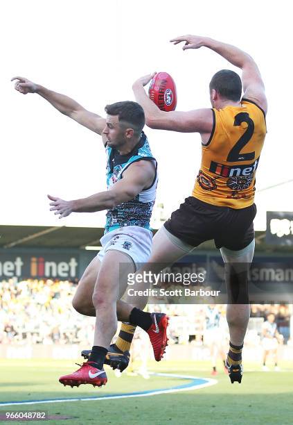 Sam Gray of the Power and Jarryd Roughead of the Hawks compete for the ball during the round 11 AFL match between the Hawthorn Hawks and the Port...