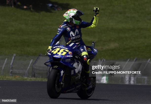 Movistar Yamaha MotoGP's Italian rider Valentino Rossi celebrates his pole position at the end of the Moto GP qualifying session in the Italian Grand...