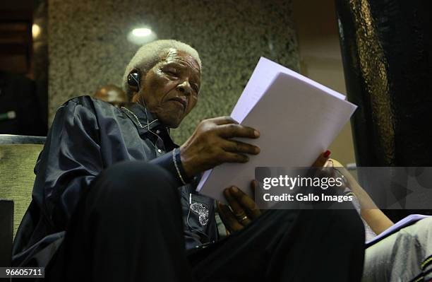 Nelson Mandela listens to President Jacob Zuma delivering his state of the nation address at the opening of Parliament on February 11, 2010 in Cape...