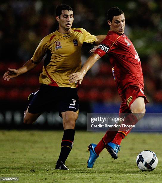 Adam D'Apuzzo of the Jets competes with Mathew Leckie of Adelaide during the round 27 A-League match between the Newcastle Jets and Adelaide United...