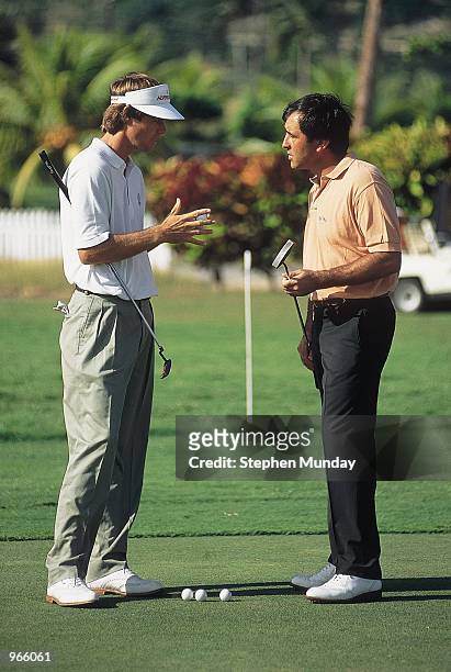 Paul Azinger of the USA chats with Seve Ballesteros of Spain on the practice green during the Johnnie Walker World Championship at the Tryall Golf...