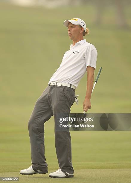 Marcel Siem of Germany reacts to a shot during Round Two of the Avantha Masters held at The DLF Golf and Country Club on February 12, 2010 in New...