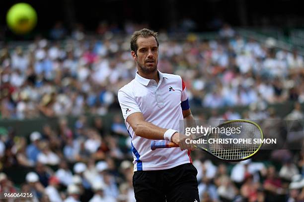 France's Richard Gasquet reacts after a point against Spain's Rafael Nadal during their men's singles third round match on day seven of The Roland...