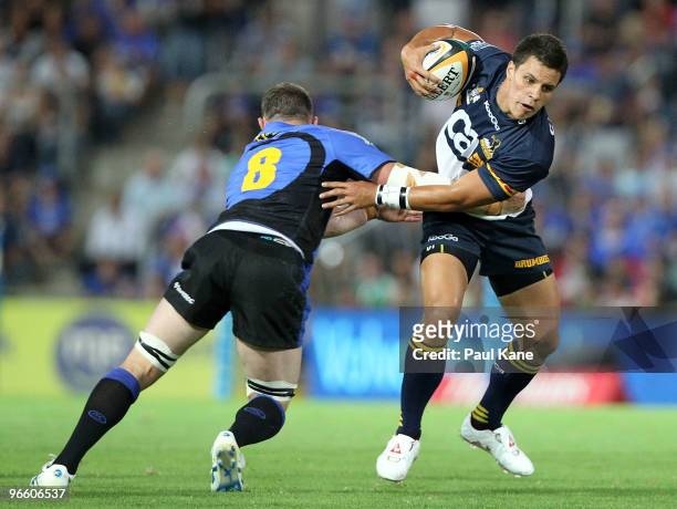 Matt Toomua of the Force breaks a tackle by Richard Brown of the Force during the round one Super 14 match between the Western Force and the Brumbies...