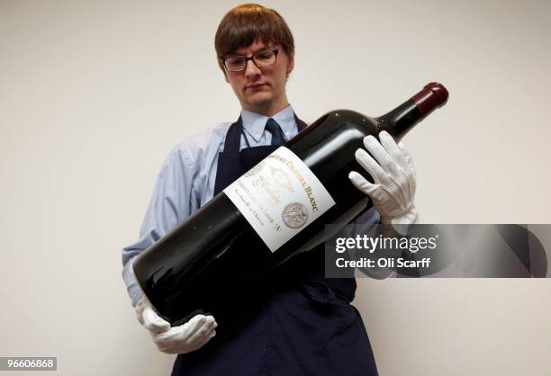 Gallery assistant for Sotheby's auction house carries a melchior of Chateau Cheval Blanc 2006 on February 12, 2010 in London, England. The melchior...