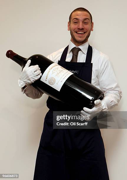 Gallery assistant for Sotheby's auction house carries a melchior of Chateau Cheval Blanc 2006 on February 12, 2010 in London, England. The melchior...