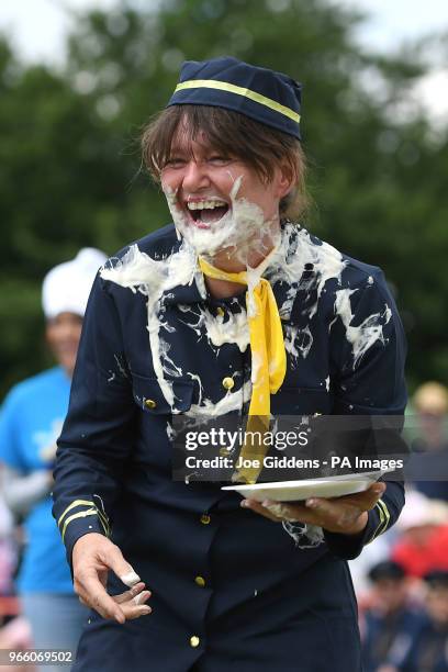 Donna Trethewey laughs after being hit in the face with a custard pie during the 51st annual World Custard Pie Championship in the village of...