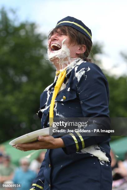 Donna Trethewey laughs after being hit in the face with a custard pie during the 51st annual World Custard Pie Championship in the village of...