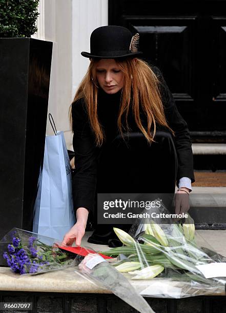 Model Olivia Inge lays a floral tribute outside the home of British Fashion designer Alexander McQueen on February 12, 2010 in London, England. Mr...